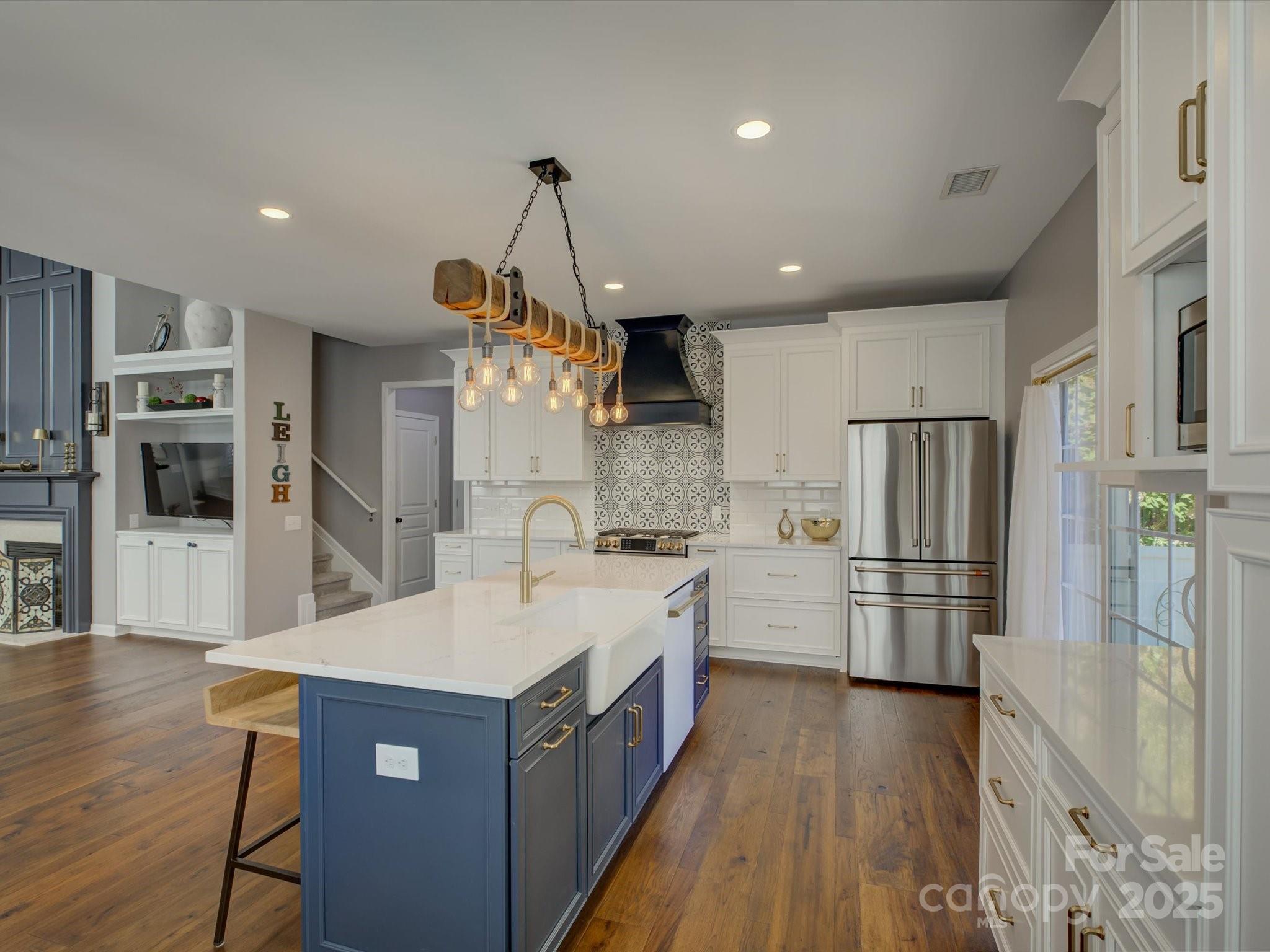 2125 Ashley River Road Waxhaw, NC 28173 - Photo 3 of 43 a large kitchen with stainless steel appliances granite countertop a refrigerator a oven a sink and a wooden floors