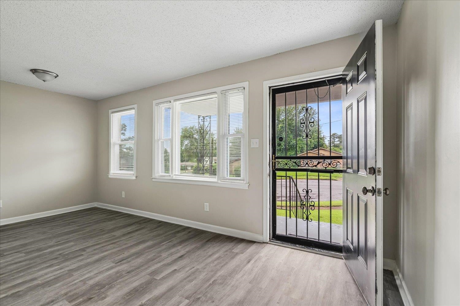 2518 Manchester Road Memphis, TN 38114 - Photo 6 of 23 Entryway with wood-finish flooring, light neutral wall paint, and white trim