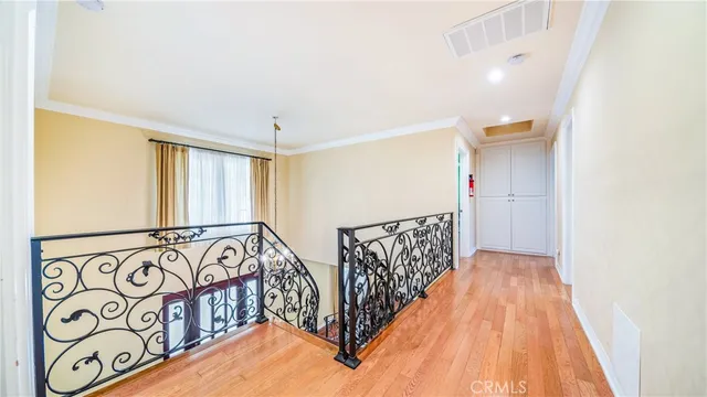 a view of hallway with wooden floor