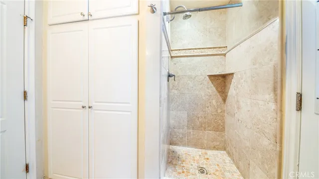an empty room with wooden floor fireplace and windows