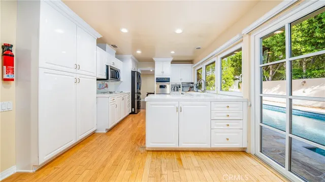 a kitchen with stainless steel appliances kitchen island granite countertop a refrigerator and a stove