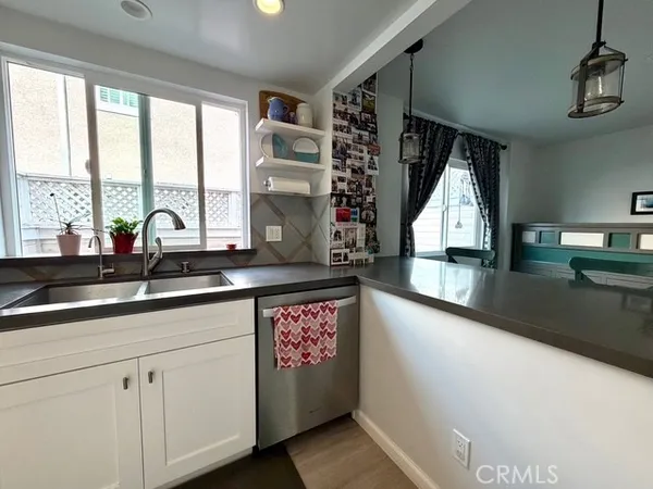 a living room with furniture a rug and a painting