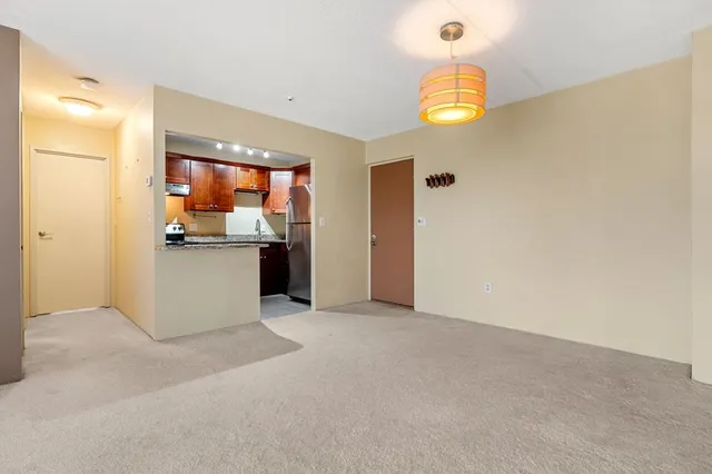a view of a kitchen cabinets and a chandelier