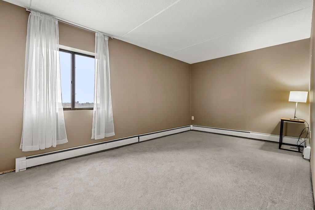 159 Franklin Street, Unit D2 Stoneham, MA 02180 - Photo 19 of 27 an empty room with windows