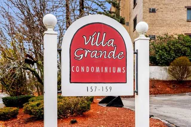 a sign board with a play ground in the back