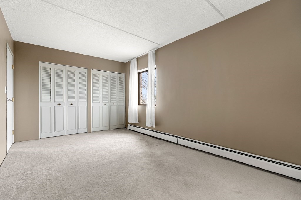 159 Franklin Street, Unit D2 Stoneham, MA 02180 - Photo 23 of 27 an empty room with windows