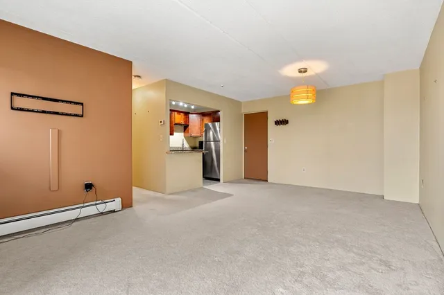 an empty room with closet and mirror