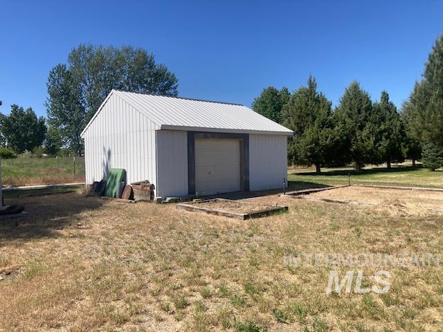 1095 County Road 70 Weiser, ID 83672 - Photo 37 of 44 Detached outbuilding with a metal exterior and a roll-up garage door