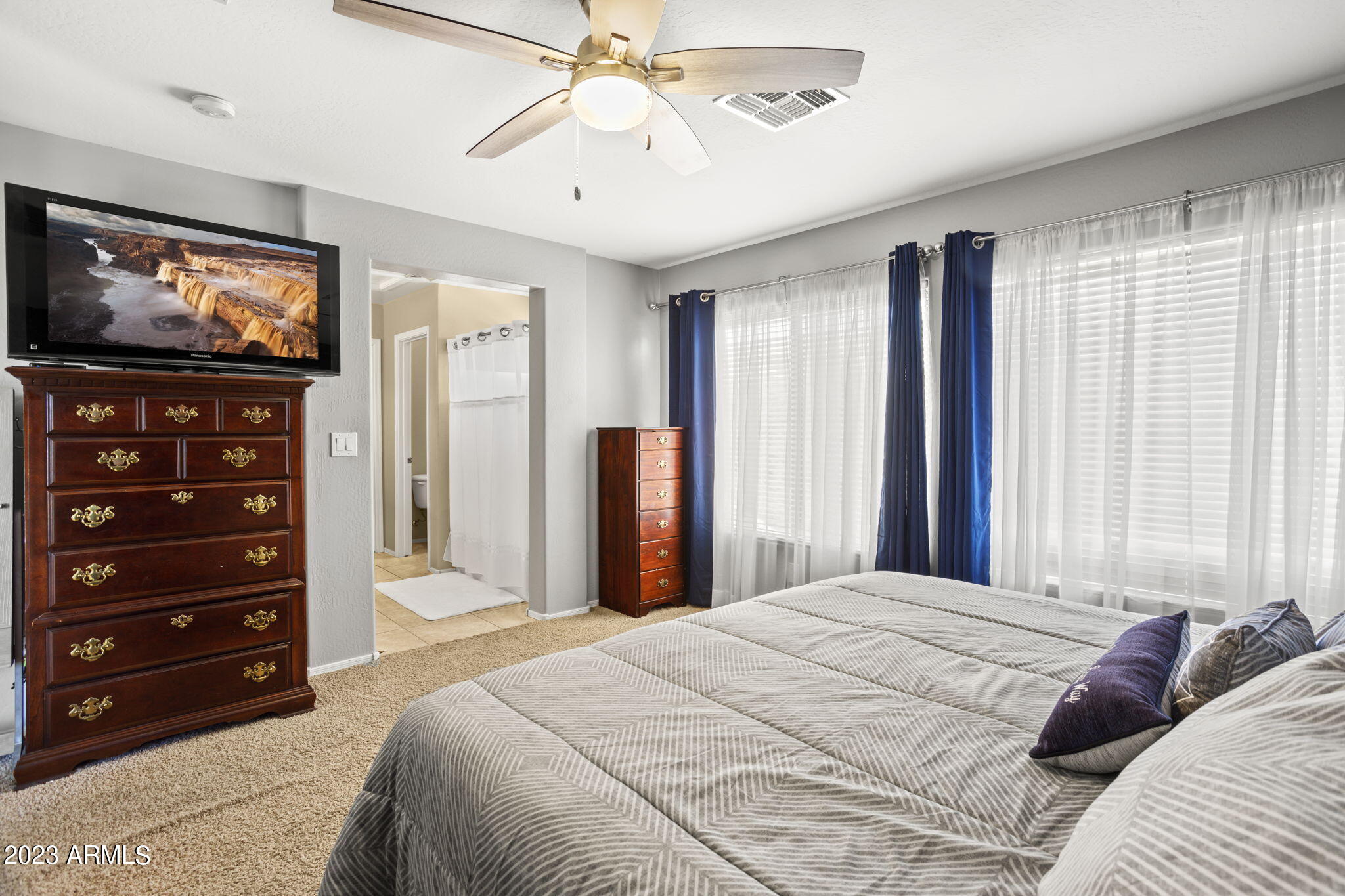 3739 West Memorial Drive Anthem, AZ 85086 - Photo 13 of 23 a bedroom with a bed and a flat screen tv