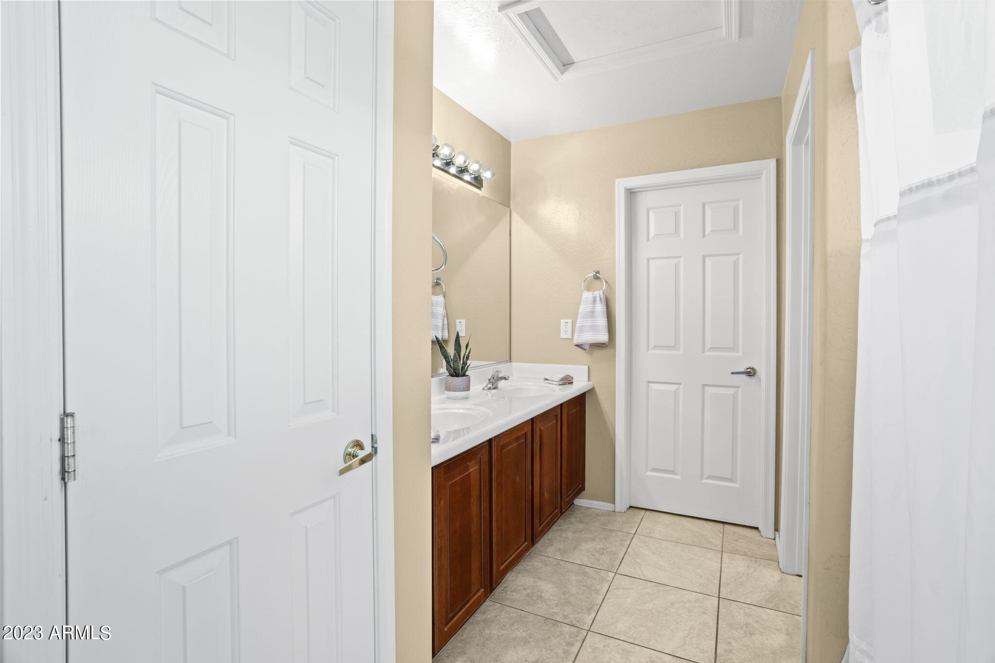 3739 West Memorial Drive Anthem, AZ 85086 - Photo 14 of 23 a bathroom with a mirror a sink and a shower