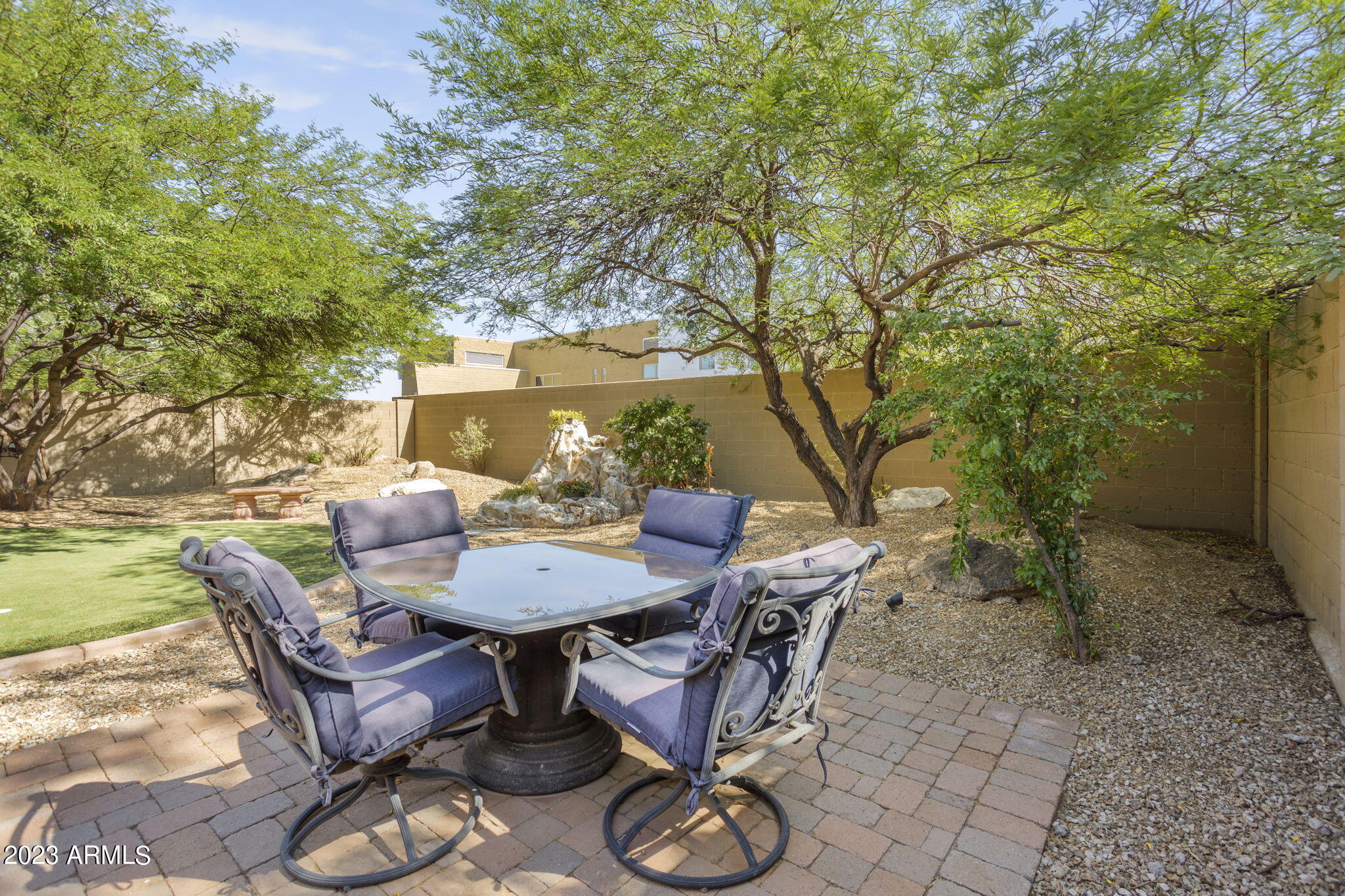 3739 West Memorial Drive Anthem, AZ 85086 - Photo 22 of 23 a view of a backyard with furniture and a garden
