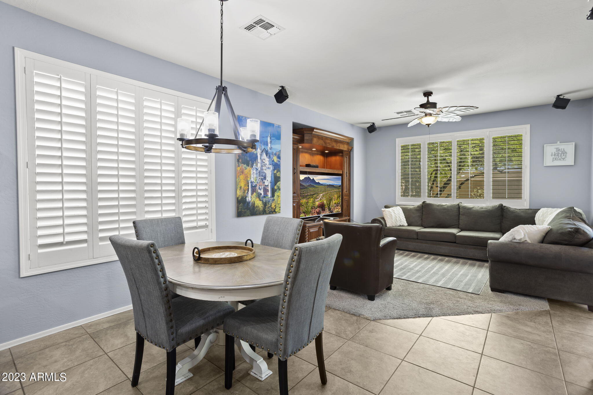3739 West Memorial Drive Anthem, AZ 85086 - Photo 5 of 23 a living room with furniture a window and a chandelier