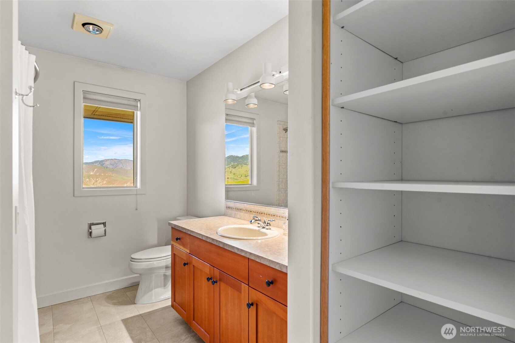 500 Connery Road Wenatchee, WA 98801 - Photo 29 of 39 a bathroom with a granite countertop sink a toilet and a mirror