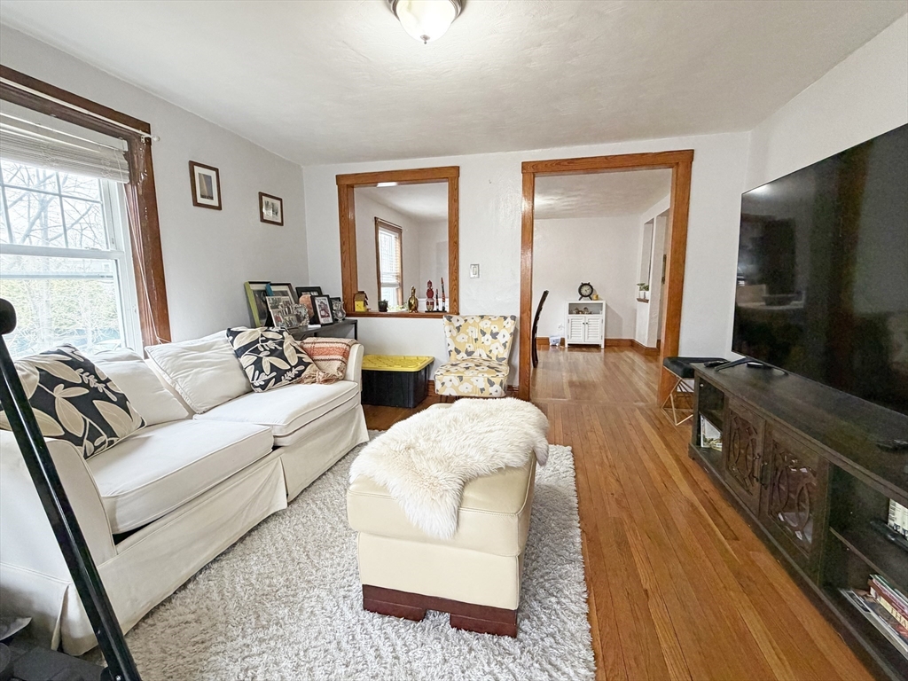 75-77 Dale Street, Unit 77 Waltham, MA 02451 - Photo 2 of 17 a living room with furniture and a flat screen tv