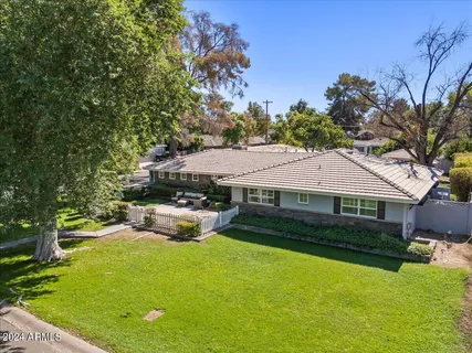 a view of a house with a yard and deck