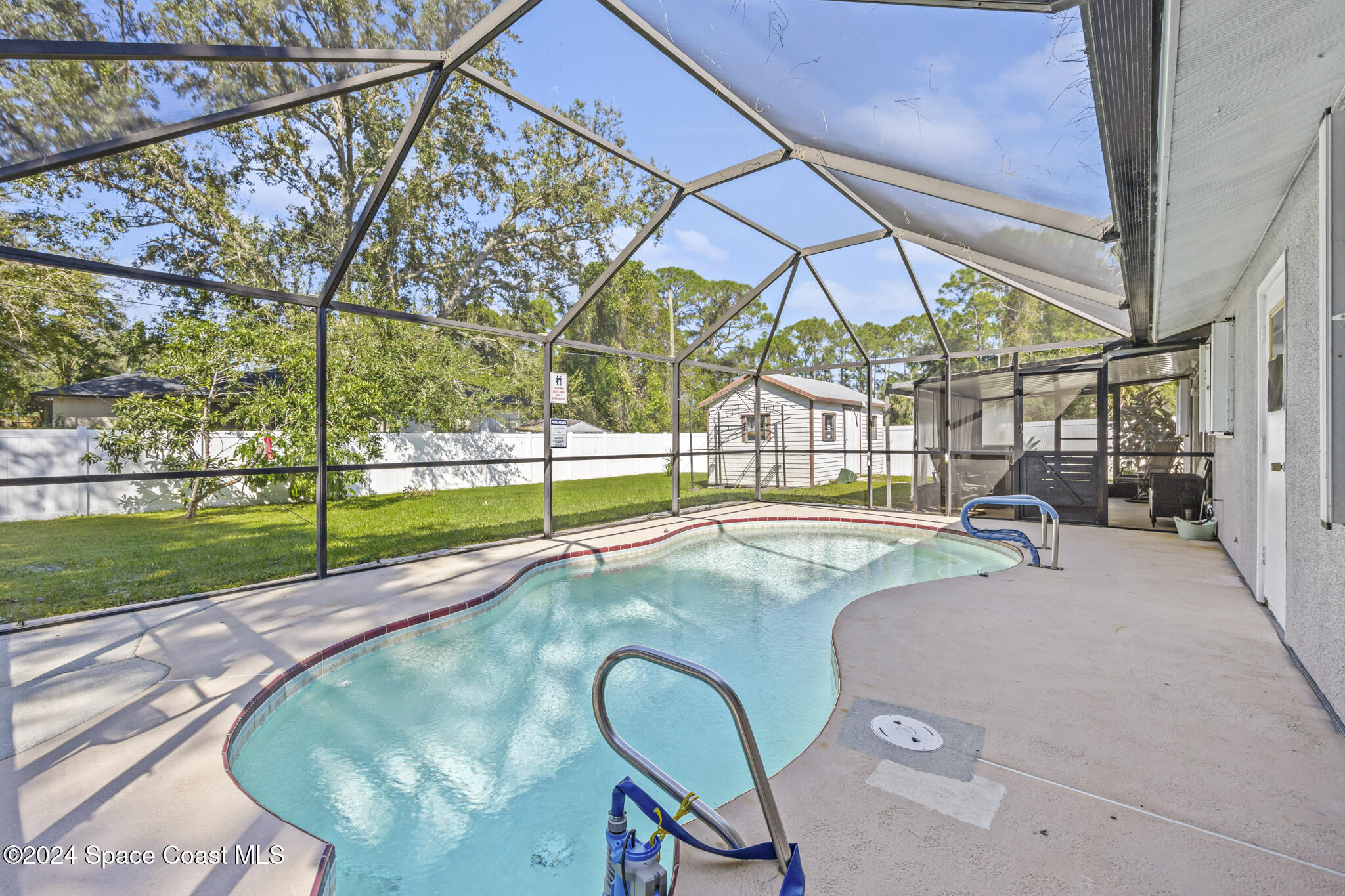 a view of swimming pool with a backyard