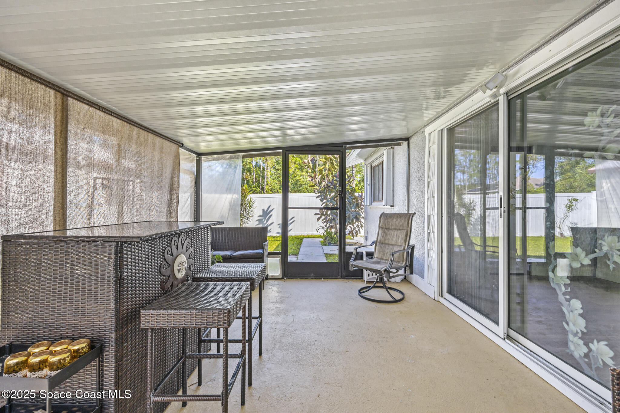797 Tooley Road Southwest Palm Bay, FL 32908 - Photo 15 of 38 a living room with furniture and floor to ceiling windows
