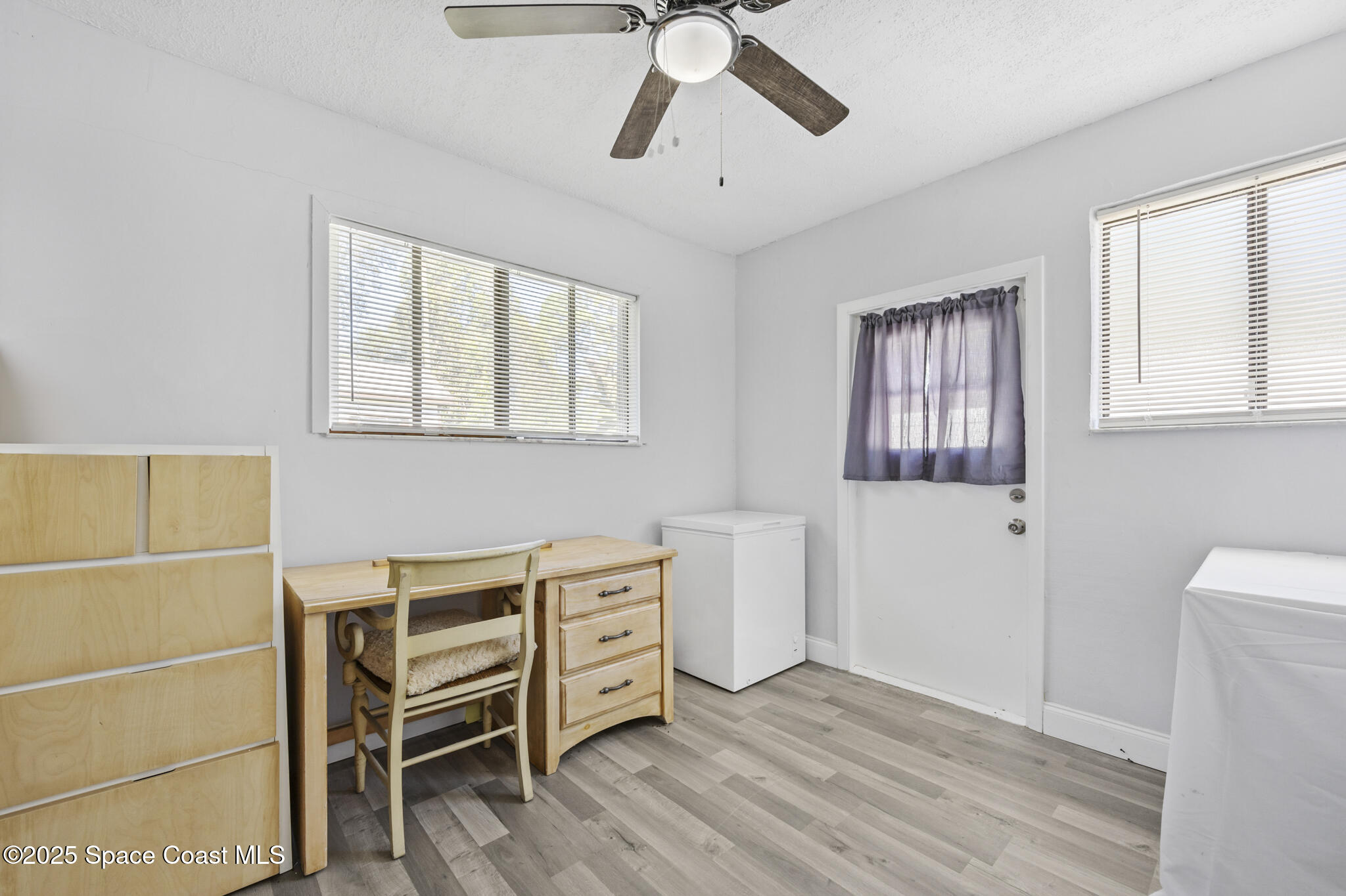 797 Tooley Road Southwest Palm Bay, FL 32908 - Photo 17 of 38 a view of a livingroom with furniture and windows
