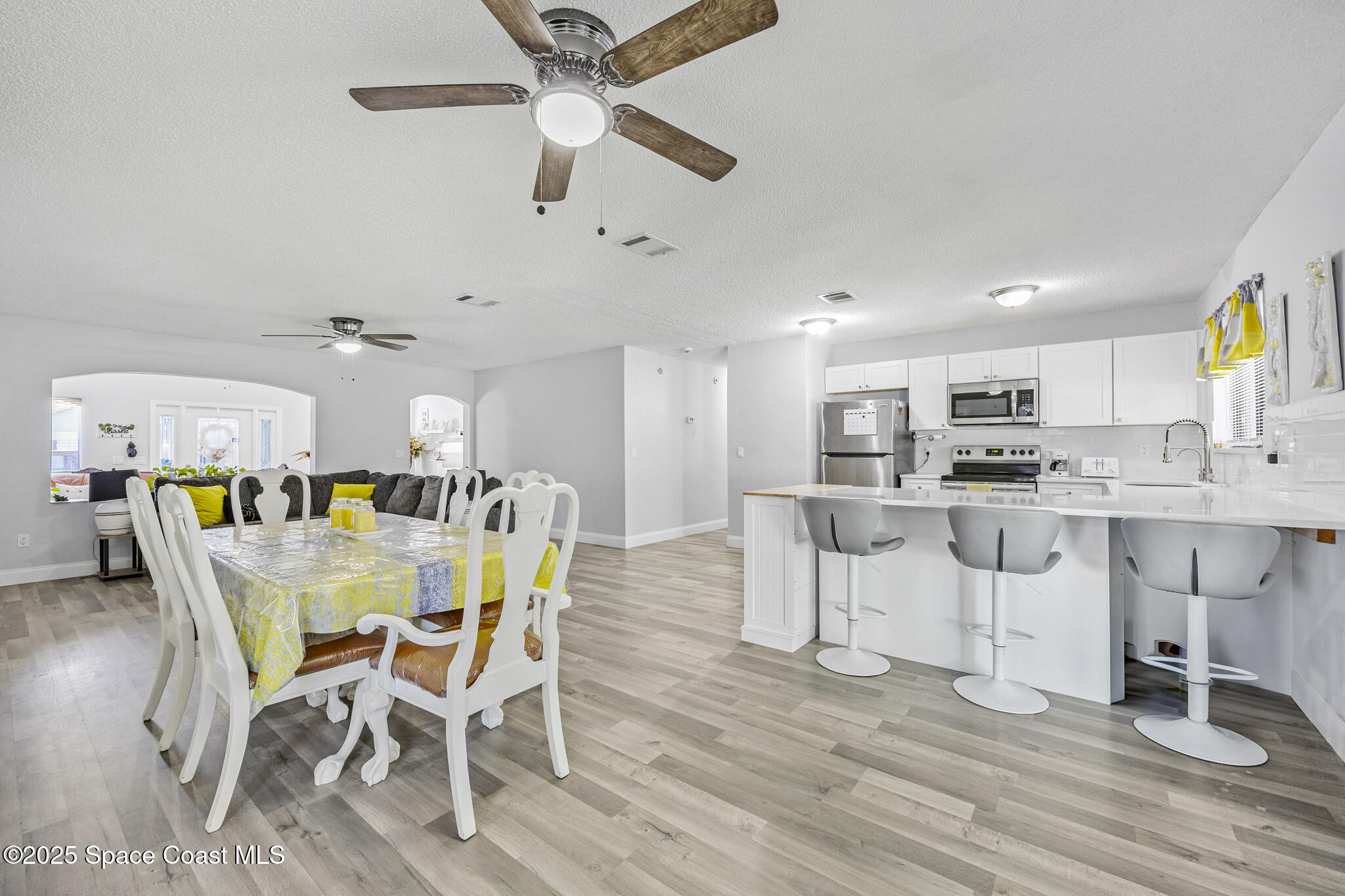 797 Tooley Road Southwest Palm Bay, FL 32908 - Photo 18 of 38 a view of a dining room with furniture and wooden floor