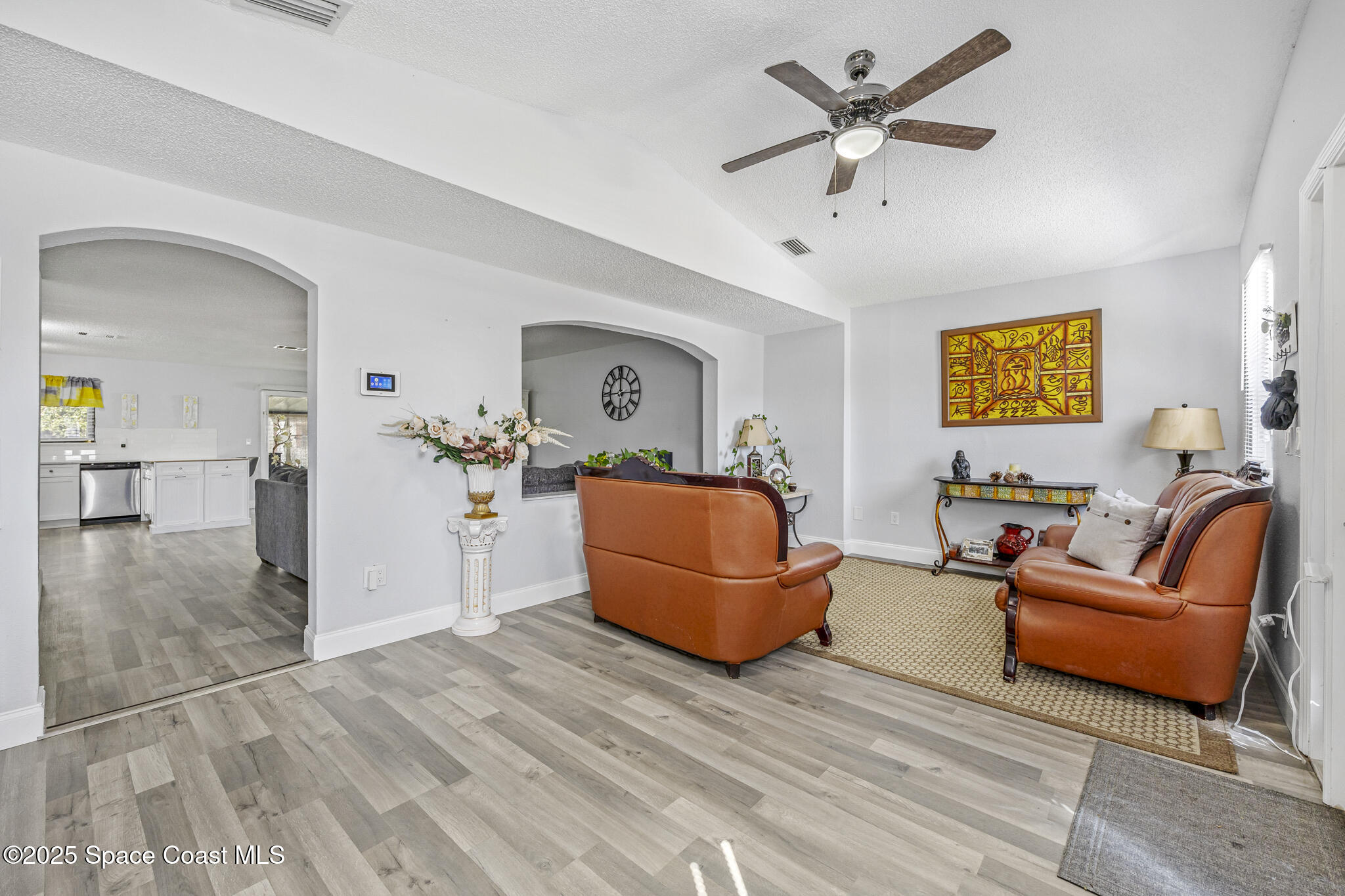 797 Tooley Road Southwest Palm Bay, FL 32908 - Photo 25 of 38 a living room with furniture and a wooden floor