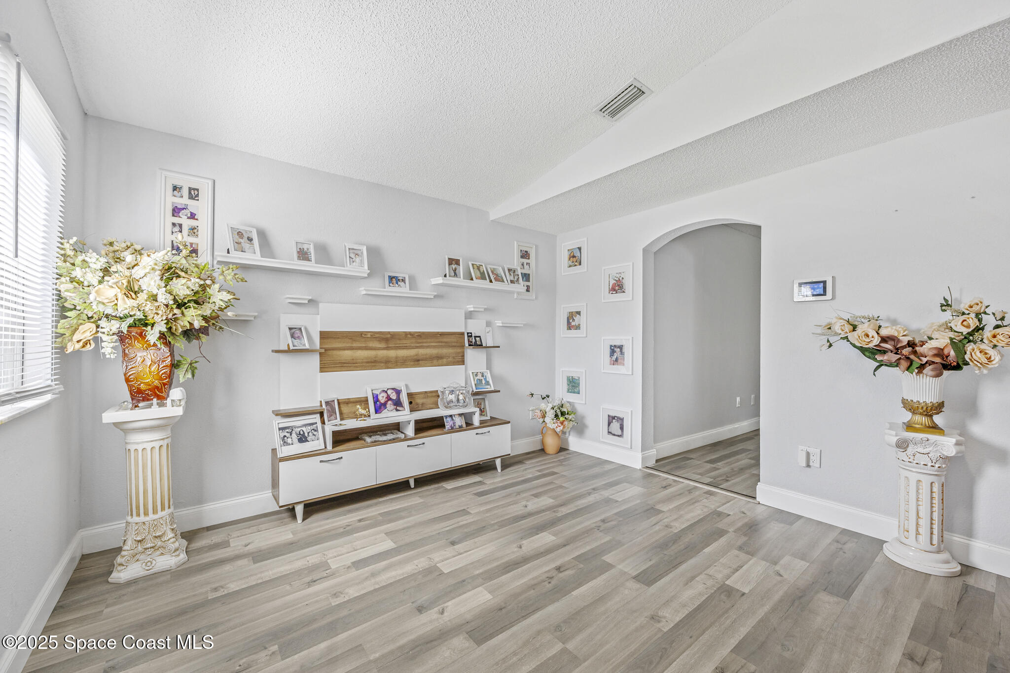 797 Tooley Road Southwest Palm Bay, FL 32908 - Photo 26 of 38 a bedroom with furniture and a potted plant