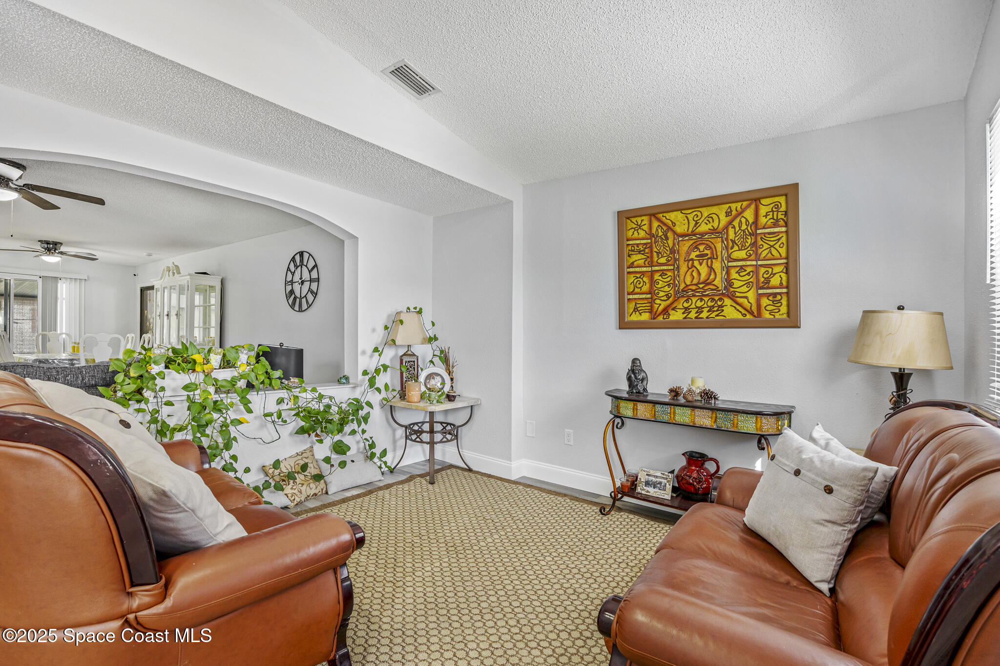 797 Tooley Road Southwest Palm Bay, FL 32908 - Photo 27 of 38 a living room with furniture and a potted plant