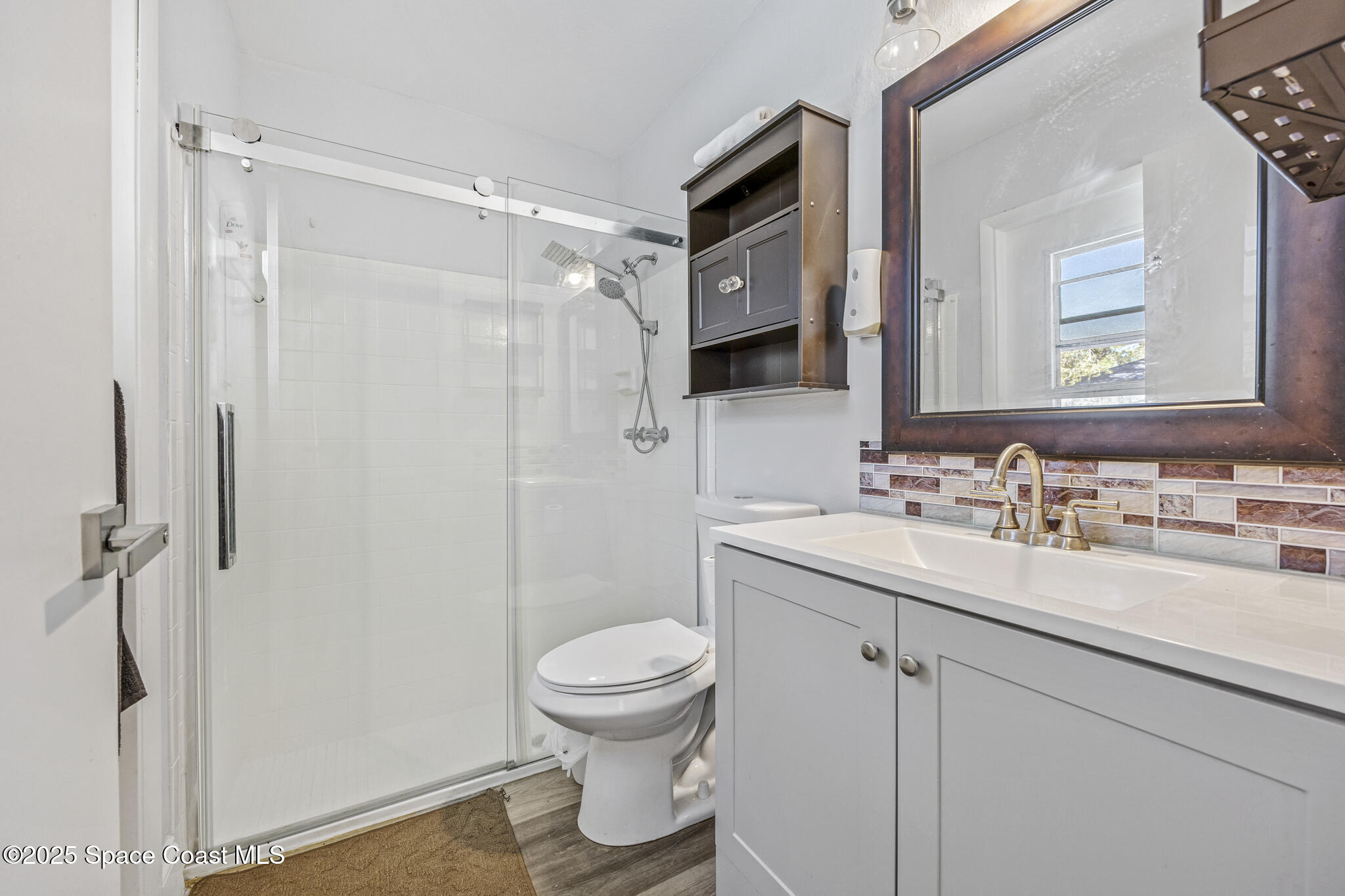 797 Tooley Road Southwest Palm Bay, FL 32908 - Photo 29 of 38 a bathroom with a sink toilet and shower