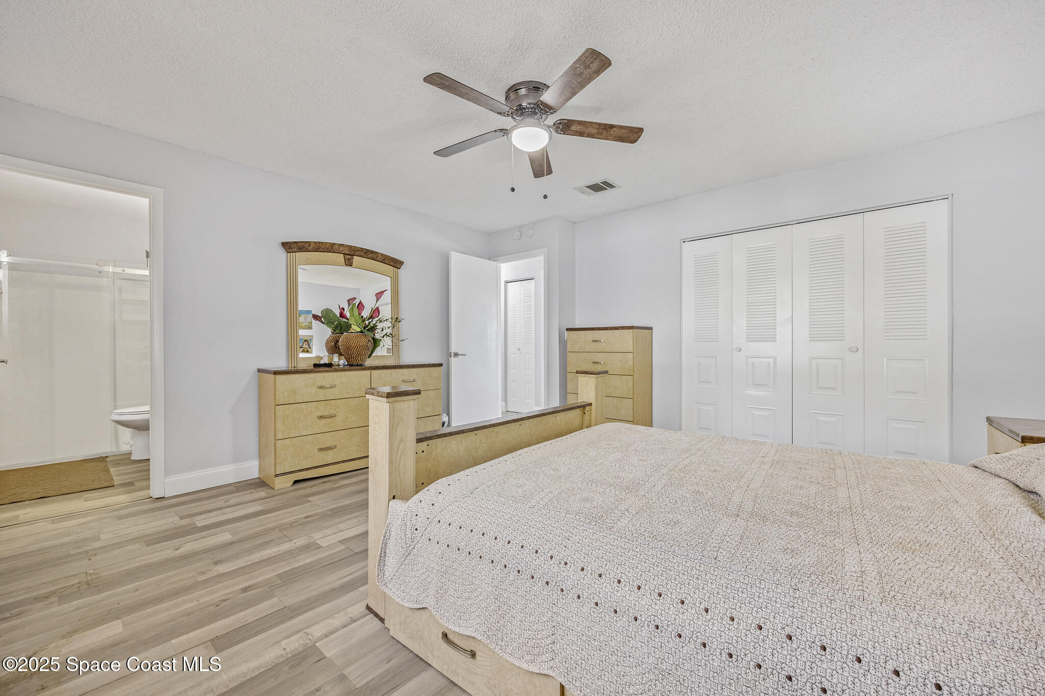 797 Tooley Road Southwest Palm Bay, FL 32908 - Photo 30 of 38 a bedroom with a bed and a dresser