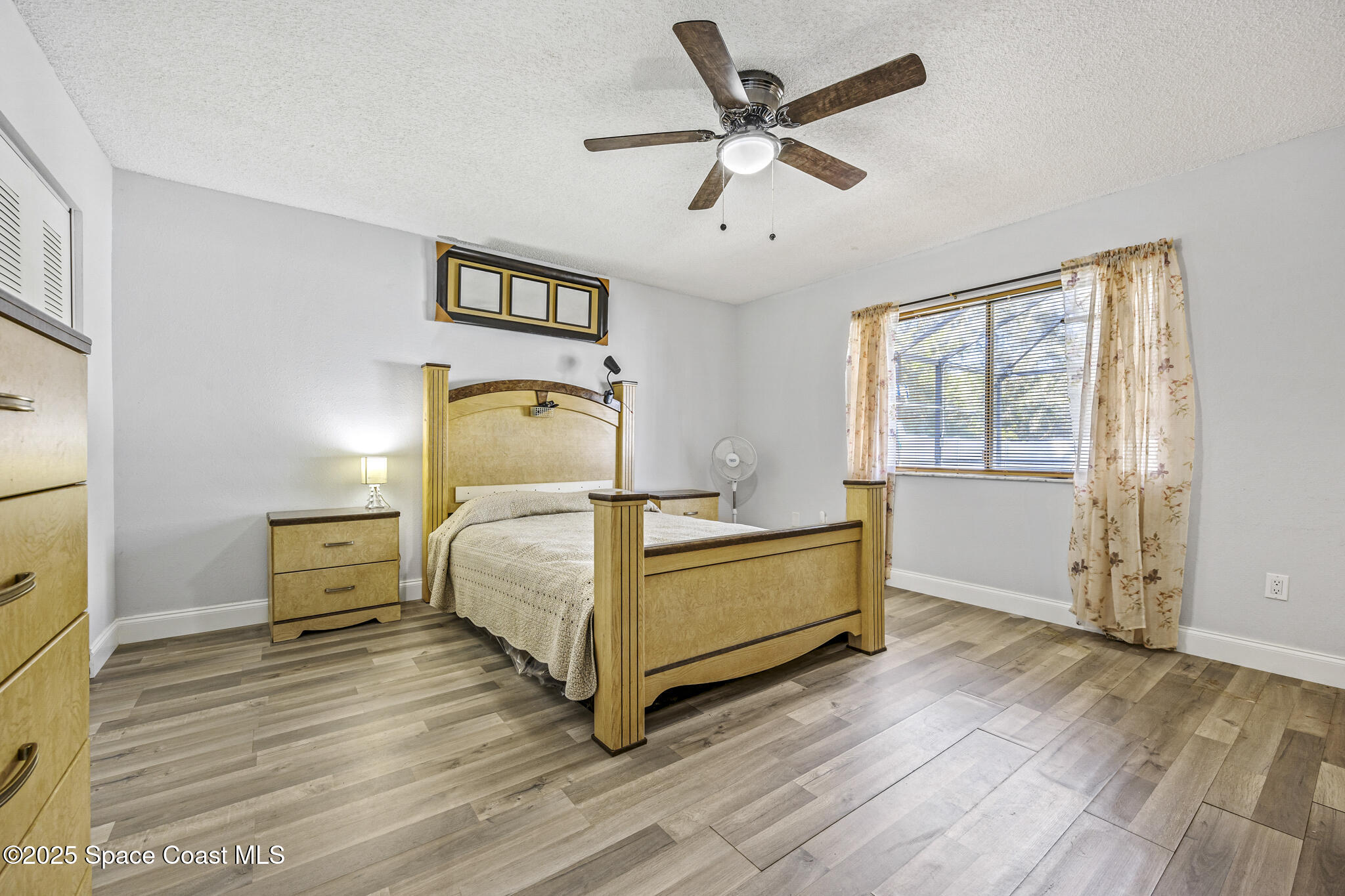 797 Tooley Road Southwest Palm Bay, FL 32908 - Photo 31 of 38 a bedroom with a bed and wooden floor