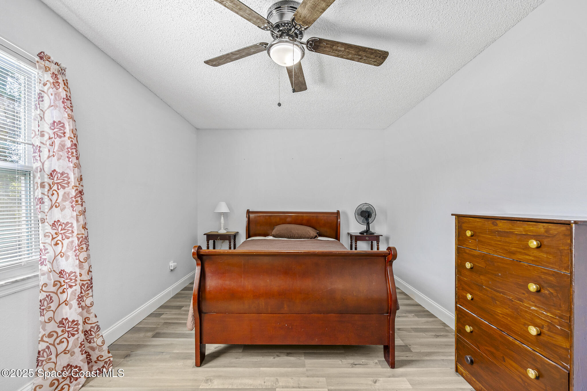 797 Tooley Road Southwest Palm Bay, FL 32908 - Photo 33 of 38 a bedroom with a bed and a chandelier