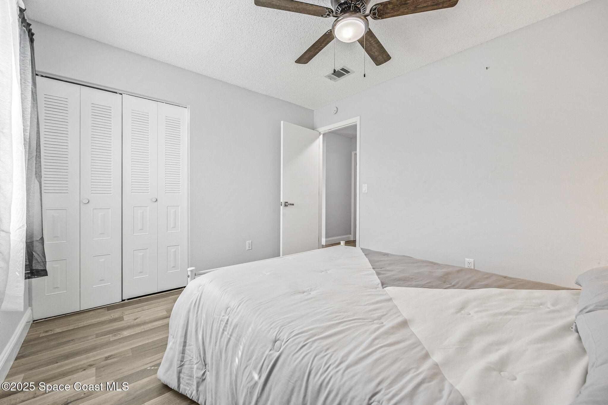 797 Tooley Road Southwest Palm Bay, FL 32908 - Photo 35 of 38 a bedroom with a bed and chandelier fan