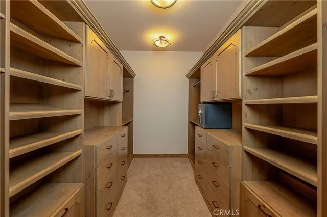 a living room with furniture a flat screen tv and a large window