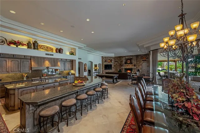 a view of a porch with couches and table and chairs with wooden fence