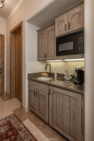 front view of a house with a palm tree