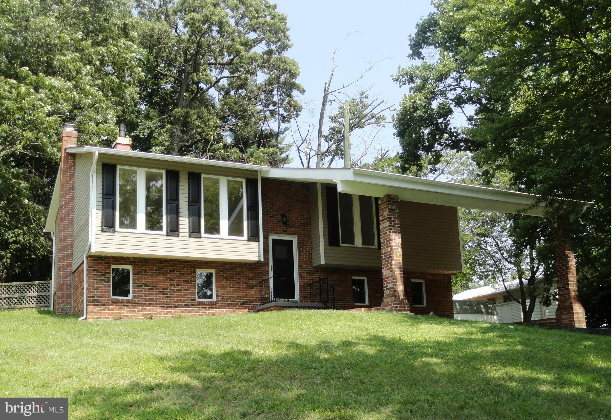 a view of a house with a yard and a porch