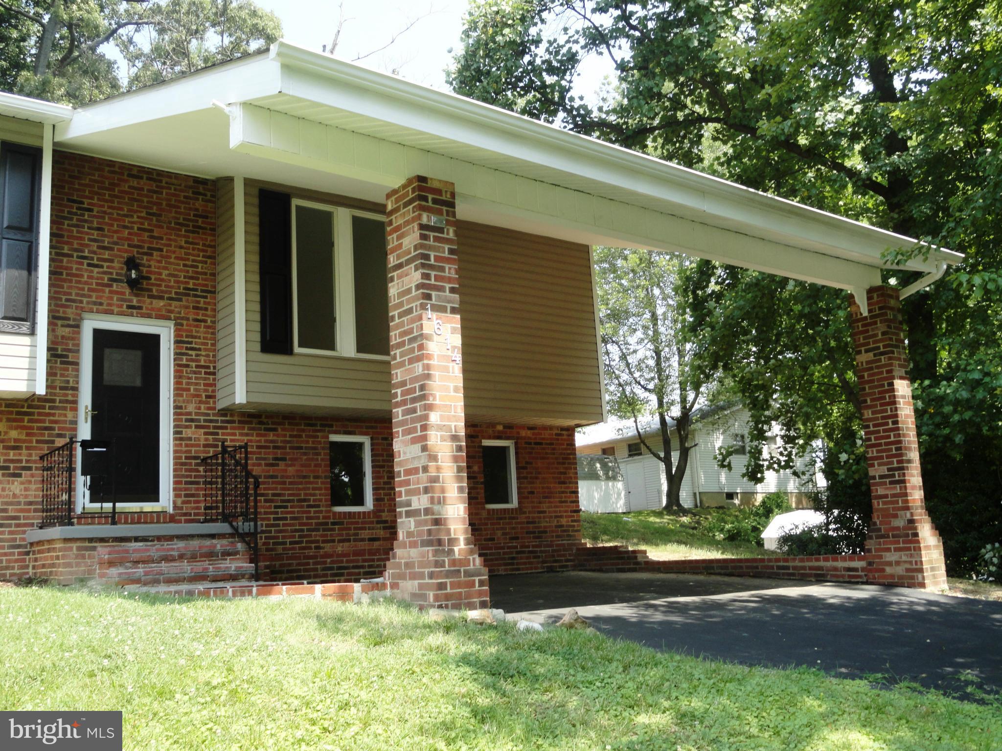 1614 Weyburn Road Baltimore, MD 21237 - Photo 2 of 25 front view of a house with a yard