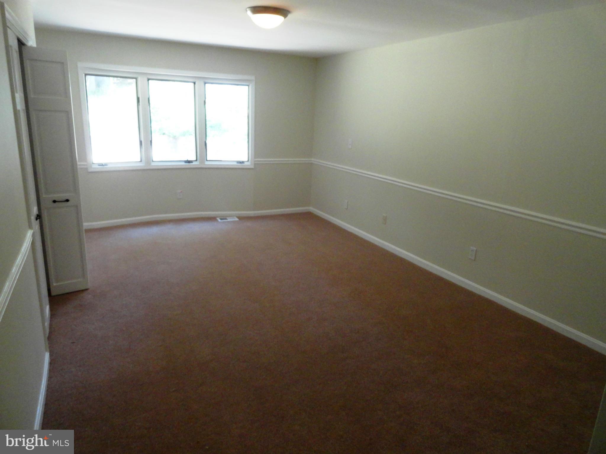 1614 Weyburn Road Baltimore, MD 21237 - Photo 12 of 25 an empty room with a empty space and windows