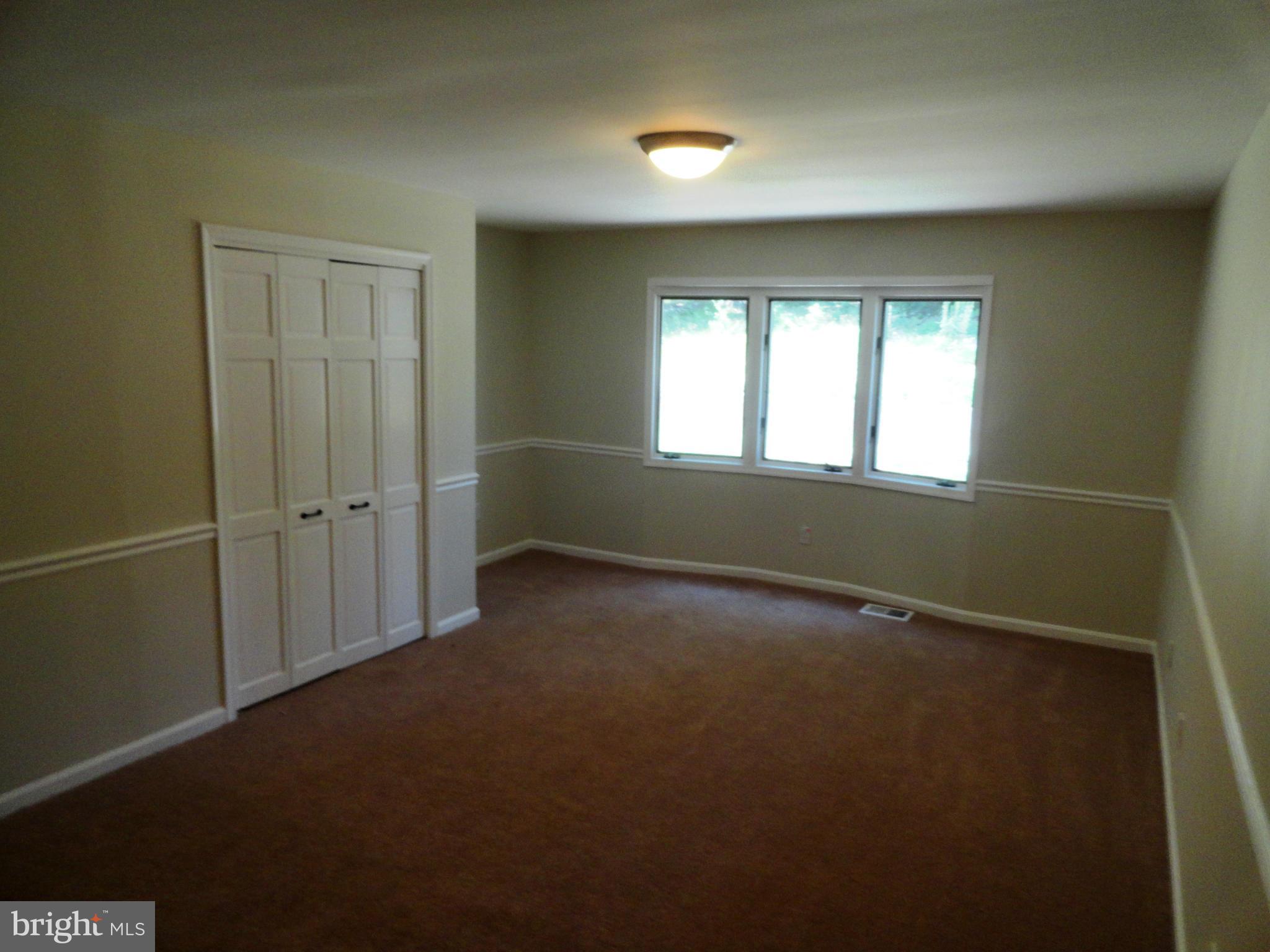 1614 Weyburn Road Baltimore, MD 21237 - Photo 13 of 25 an empty room with windows