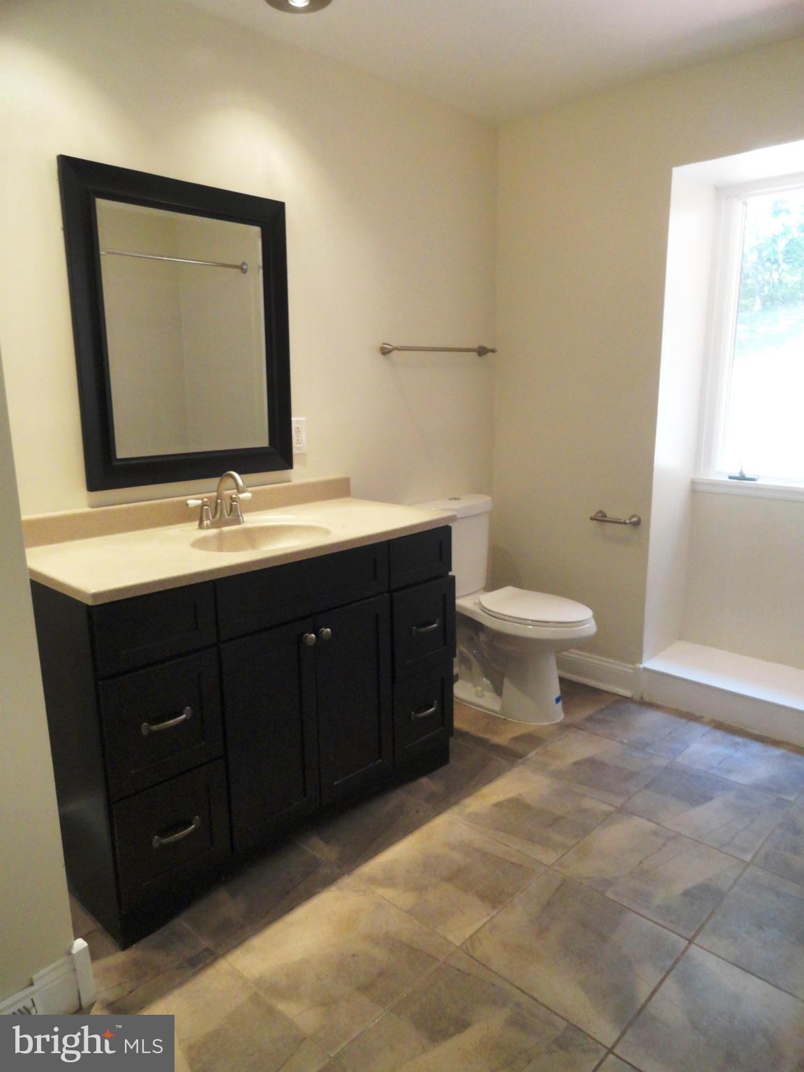 1614 Weyburn Road Baltimore, MD 21237 - Photo 15 of 25 a bathroom with a toilet sink and mirror