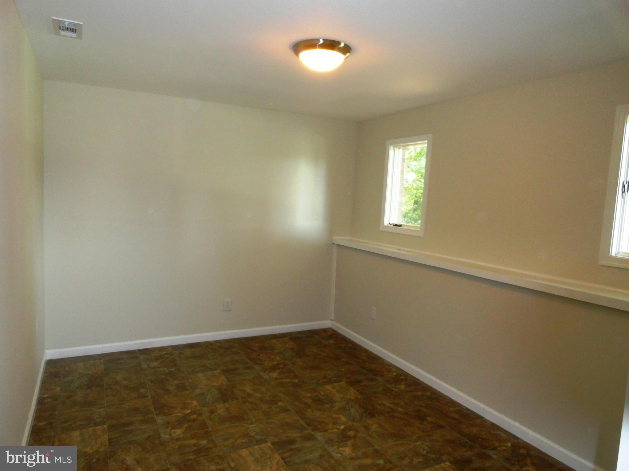 1614 Weyburn Road Baltimore, MD 21237 - Photo 18 of 25 an empty room with a window