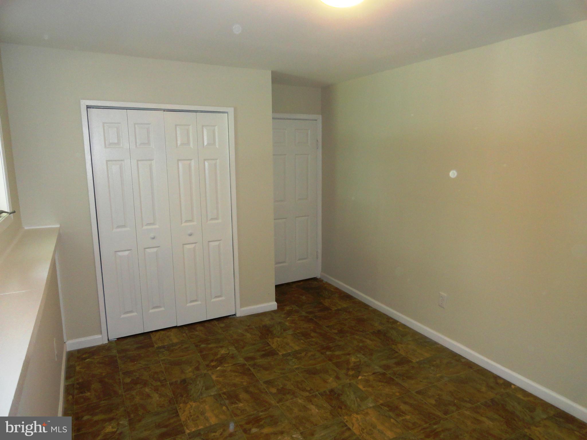 1614 Weyburn Road Baltimore, MD 21237 - Photo 19 of 25 an empty room with windows