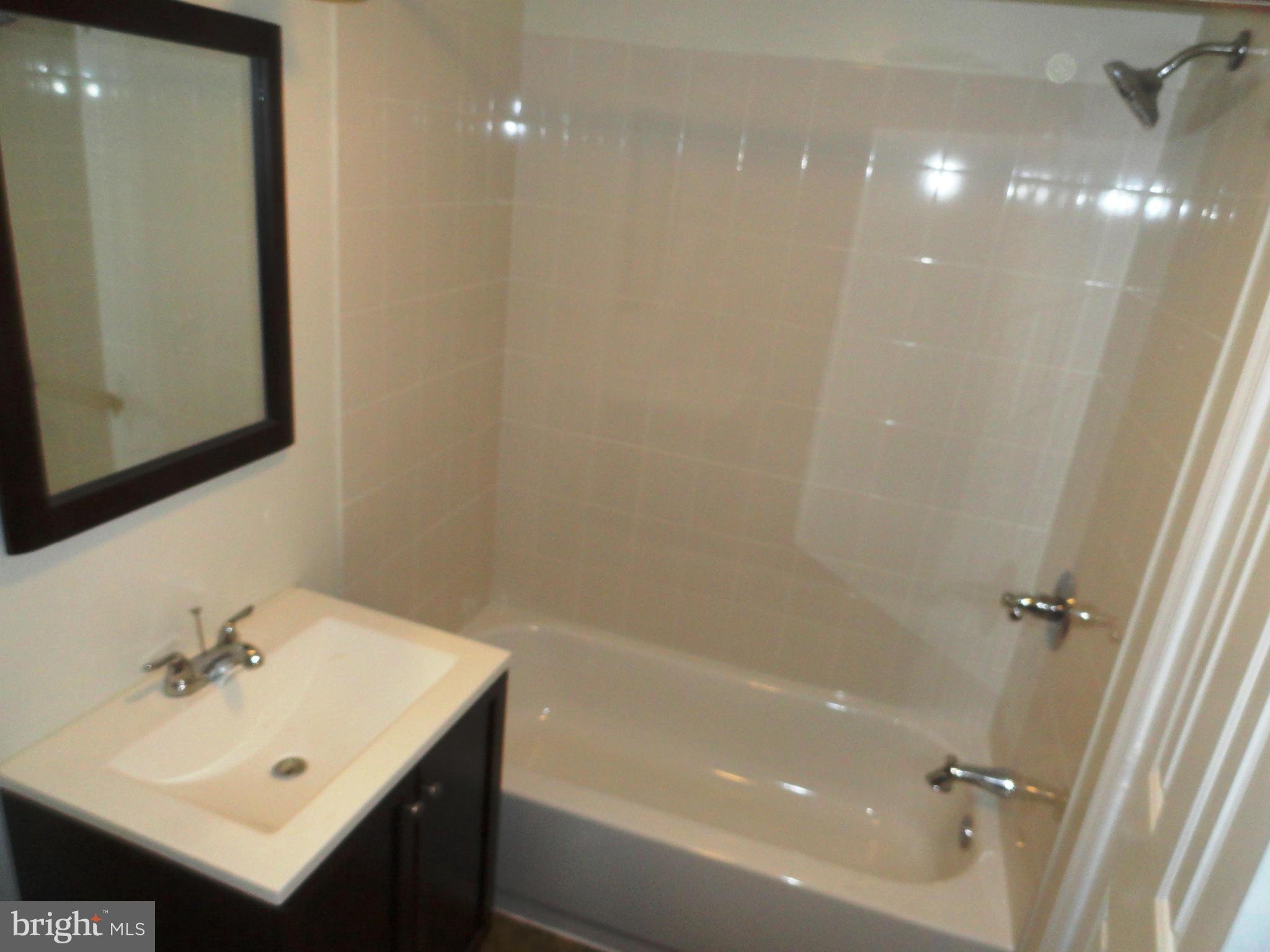 1614 Weyburn Road Baltimore, MD 21237 - Photo 20 of 25 a bathroom with a sink mirror vanity and toilet