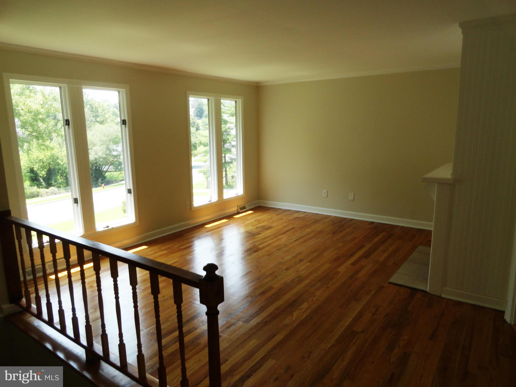 1614 Weyburn Road Baltimore, MD 21237 - Photo 4 of 25 a view of an empty room with wooden floor and a window