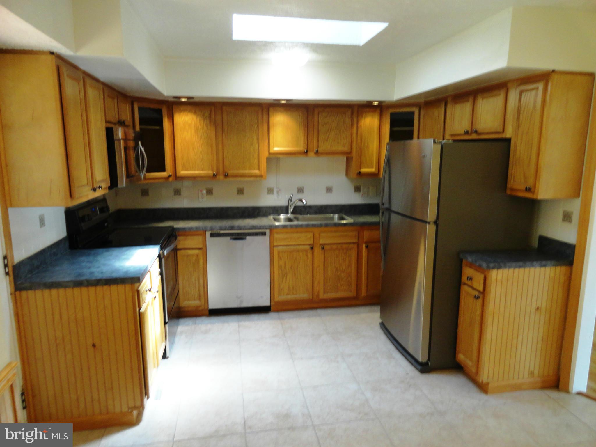 1614 Weyburn Road Baltimore, MD 21237 - Photo 8 of 25 a kitchen with stainless steel appliances granite countertop a refrigerator and a sink