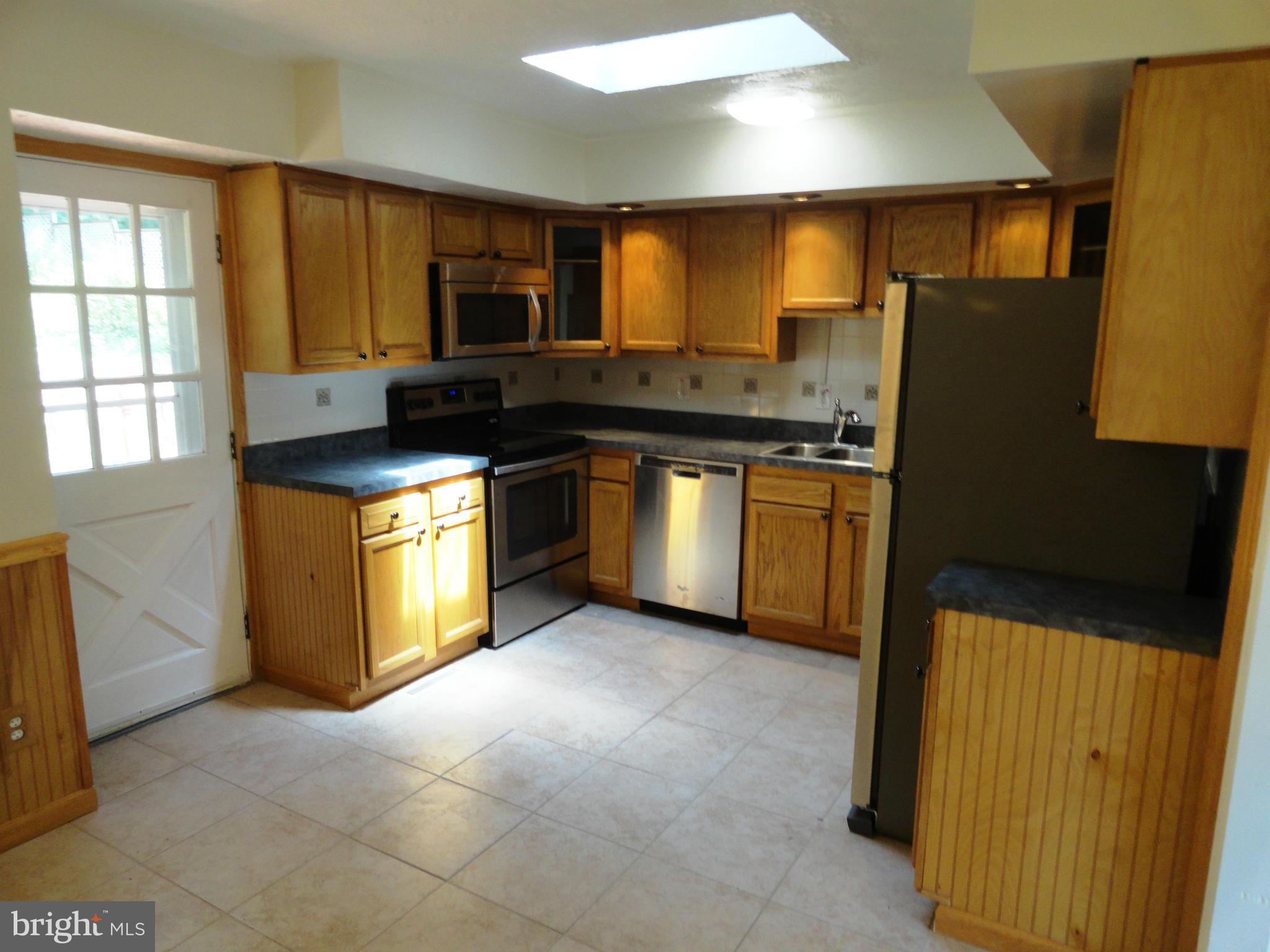 1614 Weyburn Road Baltimore, MD 21237 - Photo 9 of 25 a kitchen with stainless steel appliances granite countertop a stove a sink and a refrigerator