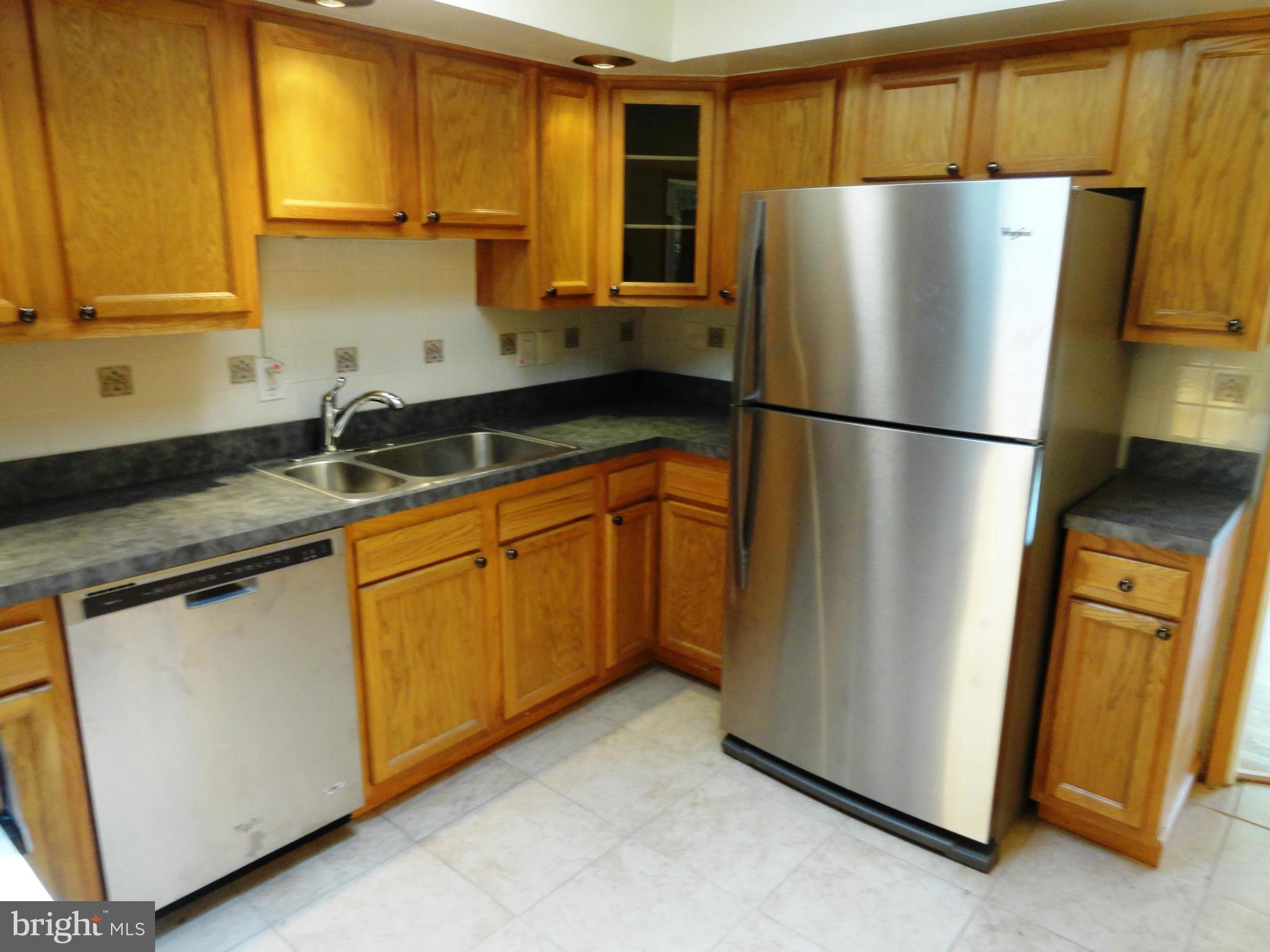 1614 Weyburn Road Baltimore, MD 21237 - Photo 10 of 25 a white refrigerator freezer sitting in a kitchen