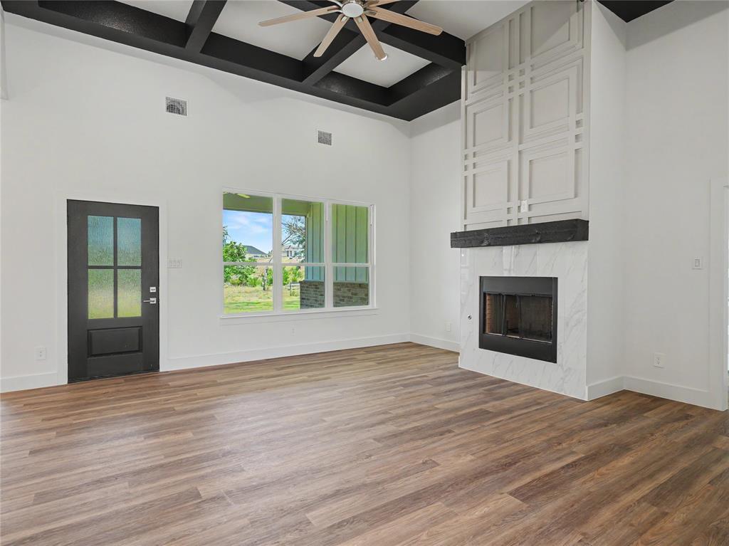 328 Slimp Bluff Azle, TX 76020 - Photo 8 of 30 Vaulted ceiling with dark-stained exposed beams and a ceiling fan