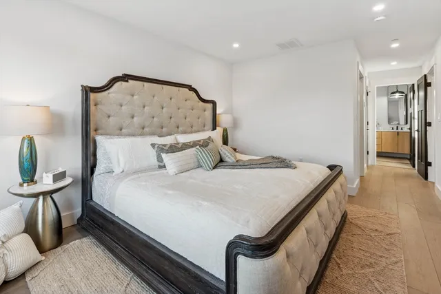 a bedroom with a bed and a chandelier