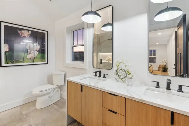 a bathroom with a toilet a sink and a mirror