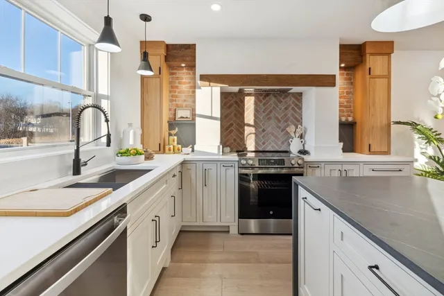 a kitchen with a sink stove top oven and cabinets